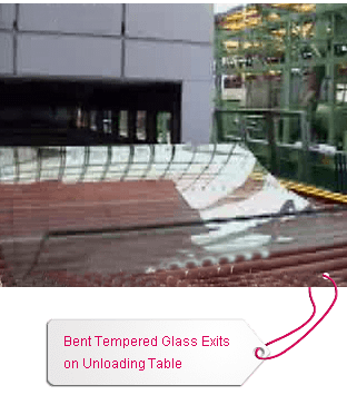 Bent Tempered Glass Exits on Unloading Table Bent Tempered Glass Exits on Unloading Table